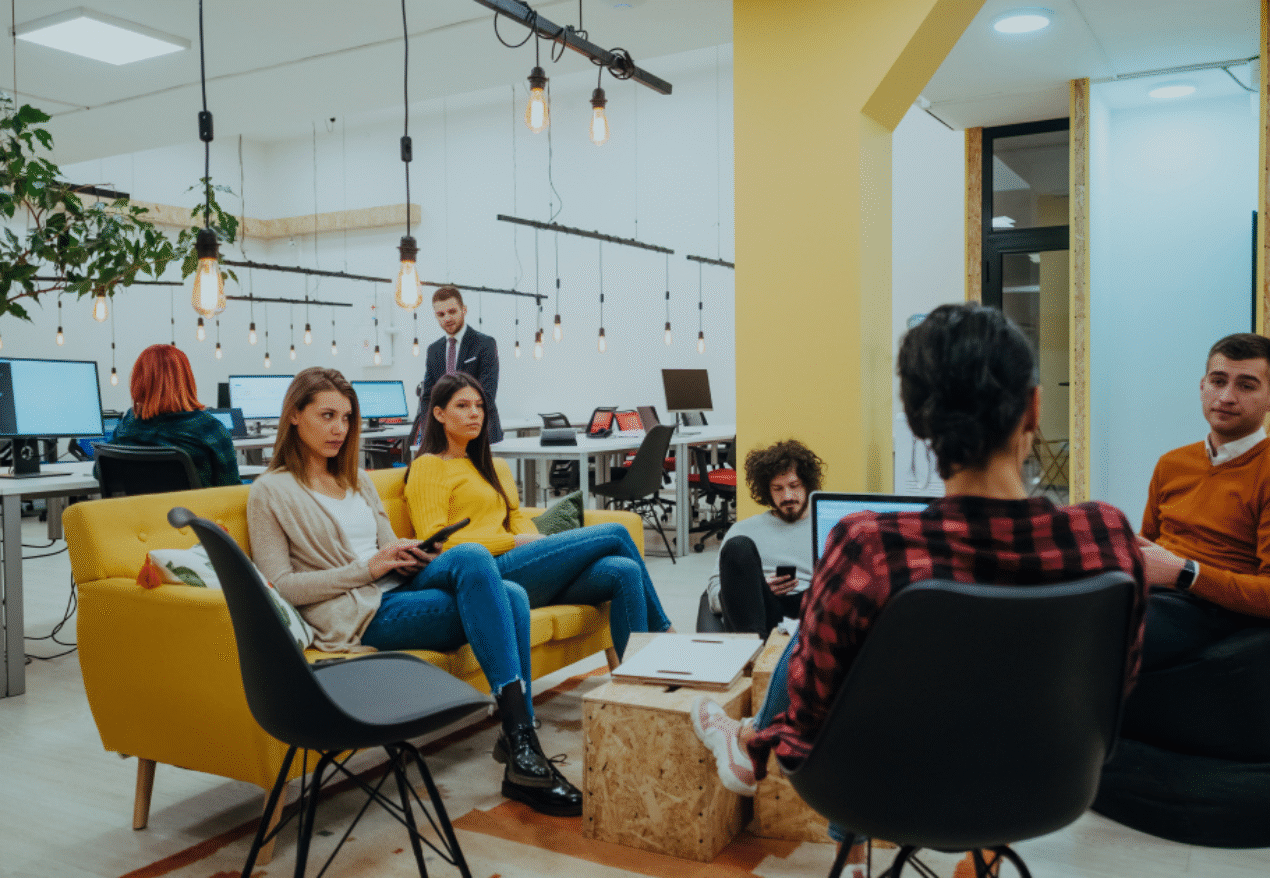 Professionals collaborating in a vibrant coworking space in Hyderabad, featuring modern furniture, open desks, and a creative ambiance.